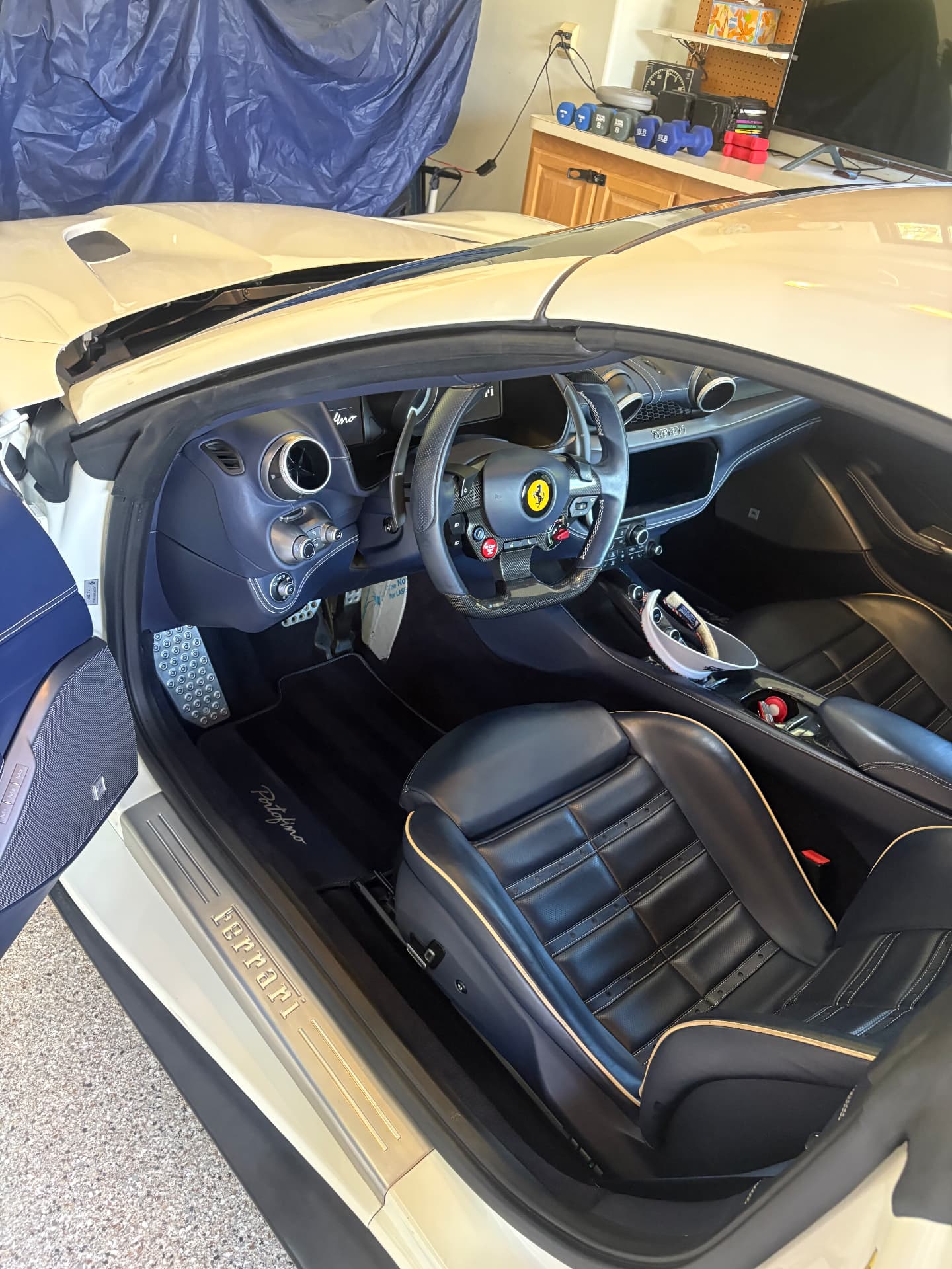 Ferrari Portofino interior showing deep blue leather seats and carbon-fiber details